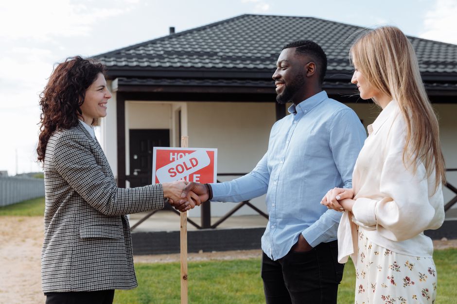 A clean, modern home with a professional 'Sold' sign in the front yard, indicating a successful and profitable real estate transaction.